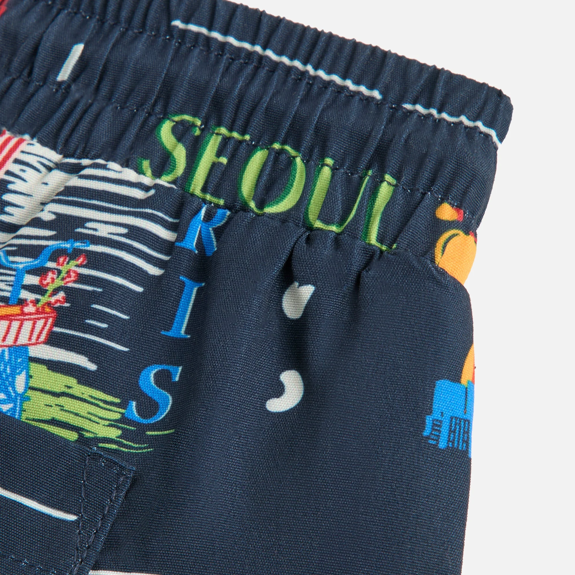 12564-kith-baby-souvenir-stamp-kai-swim-trunk-1.webp